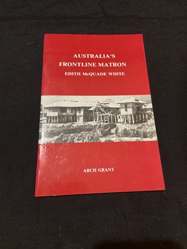 Red booklet with two staples down the side. Title is printed in white text across the top half of the cover. A black and white image of a military hospital building is in a rectangle strip across the middle. At the bottom of the page, the author's name is printed in white capital letters.