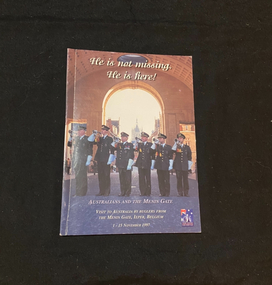 Booklet has a white spine. The cover has a coloured photo image of six bugle players performing in front of the Menin Gate, the image is overlaid with with the title in white print.