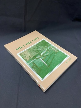 Light brown coloured book with green printed text on the cover and spine. The title is across the top of the page and the author's name in the lower right corner. In the centre of the cover is a large white square template with a green border inside, then inside that is a predominanyly green image of a partially open gate in a grassy paddock with several large trees in the background.