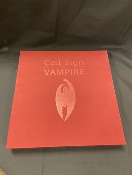 Cloth covered burgundy slipcase with the title embossed in the top centre and an image of a bat embossed in the centre.