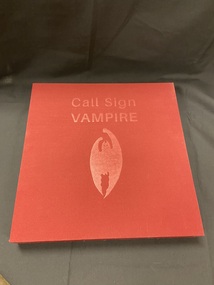 Cloth covered burgundy slipcase with the title embossed in the top centre and an image of a bat embossed in the centre.