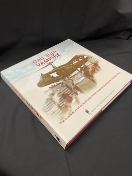 Hardcover, cloth bound, burgundy book with a white dust jacket. The dust jacket shows an image of six people ducking from the force of the wind coming from the helicopter that is landing behind them, there is blue cloudy sky above. Across the sky is printed the title in burgundy. The sub-title is printed at the bottom and below that the vampire symbol and in black print the words '1st (Aust) Field Hospital Association Incorporated'.