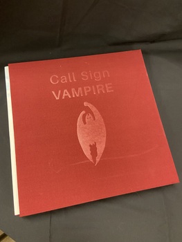 Cloth covered burgundy slipcase with the title embossed in the top centre and an image of a bat embossed in the centre.