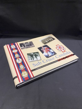 The dustjacket is cream coloured with a blue title on the spine. There is a black line that wraps around the cover an inch from the bottom. Blue, white and red stripes run vertically down the left hand side with six emblems on top of the stripes. There are four photos across the front and a nursing emblem with the years 1902 2002 alongside it. The title is in blue print below the images.