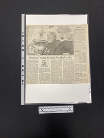 A large newspaper clipping consisting of a large black and white photo with a story of four columns of text underneath, with a column of brief stories to the right