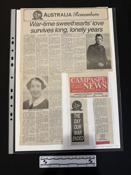 A large newspaper clipping featuring a large title, five columns of text and two black and white photos