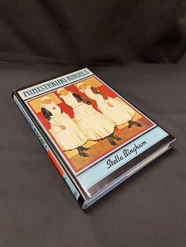 Blue hardcover book with dustjacket. The dustjacket is black with a blue strip down the spine and the title printed in black. There is a bright orange sticker on the spine with the number 72. The cover is blue and black with black text. It shows an illustration of three war nurses.
