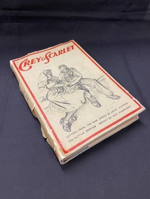 Grey dust jacket covered hardback book. There is a red border around the front and the title printed in red across the top. The centre of the cover shows a hand-drawn image of a nurse tending a wounded patient at his bedside. The subtitle is printed across the bottom in black.
The title is printed in red at the top of the spine and below that, in black print, it reads : 'with a forward by Her Majesty Queen Mary'.
The dustjacket is very torn, especially along the spine.