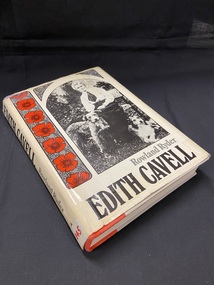 Hardback book with dustjacket. The dustjacket is cream in colour. Along the spine the title is printed in large black letters, followed by the author's name, and at the bottom is a white sticker with 'B45' handwritten in red texta.
The front of the dustjacket shows a black and white photograph of a well-dressed lady sitting on a bench with a dog either side of her. Down the left side of the image is a vertical panel with seven red poppies. The title and author are printed across the bottom of the cover.
