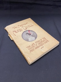Small, worn paperback book with a faded and discoloured cream cover that is torn along the spine. There is a portrait of Nurse Cavell in a round template in the centre of the cover and the title and sub-title are rinted above and below the image in brown print.