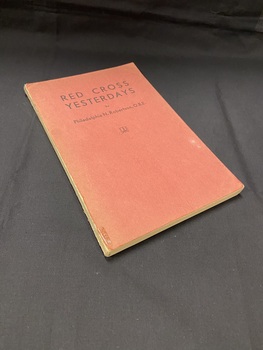 Book with a red cardboard front and back cover, but a bare spine showing the page binding. The cover is faded and has the title and author printed in black text across the top.