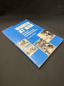 Blue paperback book with title printed in white along the spine and front cover. There are four black and white photos of nurses tending wounded soldiers in white-bordered templates across the bottom of the cover.