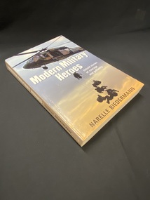Light brown spine with white printed title across it. The front cover shows a helicopter in the grey sky with seven soldiers being lowered to the ground, the title is printed across the middle and the author's name appears at the bottom of the image.