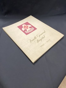 Olive green hardcover book. The cover has a maroon coloured rectangle template in the middle with the hospital symbol; the title appears below in a darker olive print.