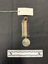 Photo of the obverse of a Australia Service Medal. Made from nickel-silver, the obverse has a central and textured design of the Australian coat of arms. The face has 'THE AUSTRALIA SERVICE MEDAL/1939-1945' inscribed. The rim of the medal is engraved with 'QF140158 M. L. JACKSON'. The ribbon is tactile, feeling ribbed under finger. This photograph is taken upon a black background, with a scale card and object number included.