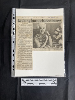 A newspaper clipping with a title, a large column of text and a large black and white photo