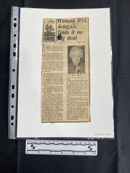 A newspaper clipping consisting of a title, two columns of text and a small black and white photo