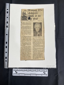 A newspaper clipping consisting of a title, two columns of text and a small black and white photo
