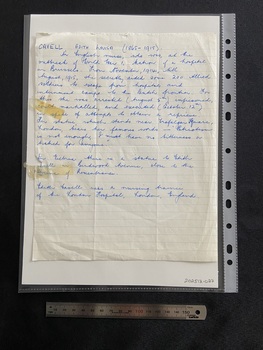 Handwritten short biography in blue ink on a lined piece of notepaper. There are two old stickytape marks on the left hand side.