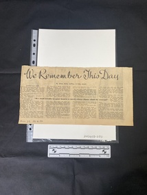 A newspaper clipping with a large title and four columns of text beneath