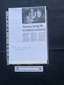 A photocopy of a newspaper clipping of a black and white photo above three columns of text