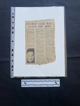 A newspaper clipping of three columns of text with a small black and white photo