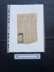 A newspaper clipping of three columns of text with a small black and white photo