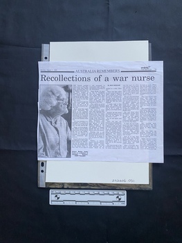 A photocopy of a newspaper clipping featuring a large black and white photo and five columns of text