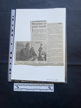 A newspaper clipping consisting of two columns of text and a black and white photo