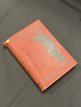 Small hardcover book with a dark red dustjacket. The spine is torn at the top and bottom and there is an old tape mark on the bottom of the spine. The front has a black silouette of a soldier playing a bugle along the right side edge, beneath him is a solid black line with the author's name printed below across the bottom of the cover. The title is printed in black ink across the top. 
The title and author are also printed in black text on the top part of the spine, further down it reads '3/6 net'  and 'Herbert Joseph'.