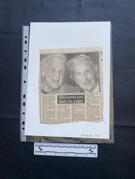 A newspaper clipping consisting of four columns of text and a title under a large black and white photo