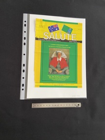 Yellow background overlaid by a large green vertical strip down the centre that contains a painted image of a military nurse. There is a wide horizontal yellow strip across the top of the page with the journal details printed in white text and two flags crossing in the centre. There is a thin horizontal strip across the bottom of the page with black text printed in it.