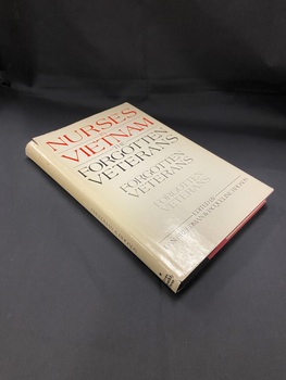 Faded cream dustjacket, discoloured and slightly worn around the edges. The title is faintly visible in red print along the spine next to the surnames of the editors printed in black. On the front of the dustjacket 'Nurses in Vietnam' is boldly printed in red across the top. The editors names appear at the bottom in black text. In between are the words 'Forgotten Veterans' repeated down the page three times, each time in a lighter print and a smaller font size.