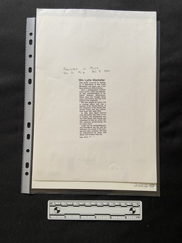 Photocopy of a newspaper clipping that contains a column of printed type with a bold print heading and five short paragraphs, there are handwritten publication details above the printed article.