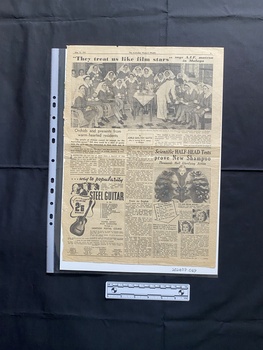 A large newspaper page featuring a large black and white group photo above a related story and ads