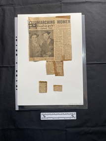 Newspaper clipping of articles on both sides, with some parts becoming seperated. One side has a black and white photograph of three woman wearing medals and holding a floral tribute.  The other side has a black and white photograph of two women in Army nursing uniforms looking at the camera.  There are a range of articles on both sides.