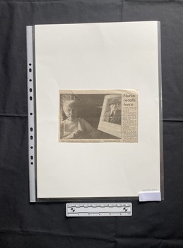 A small newspaper clipping with one column of text and a large black and white photo