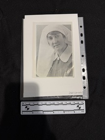 Black and white portrait photograph of a younger woman in a nurses uniform with a white collar and headdress.  Photo is a little blurry.