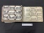 An example of the inside layout. This page selection has nine black and white 3.5 inch x 2.5 inch photos laid out in three lines of three. The left side page is covered by a page of glassine paper that has discoloured and worn.