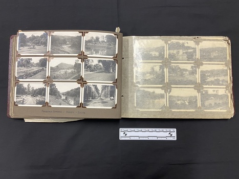 An example of the inside layout. This page selection has nine black and white 3.5 inch x 2.5 inch photos laid out in three lines of three. The left side page is covered by a page of glassine paper that has discoloured and worn.