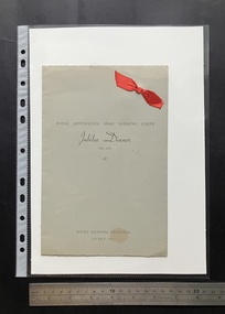 Grey folded card with deckled edges, black text and a red fabric ribbon tied through the card in the top right corner.