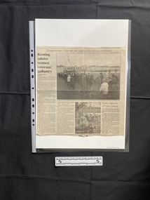 A large newspaper clipping of two stories with a large and a small black and white photo