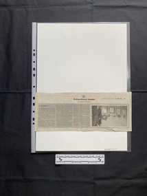 A newspaper clipping consisting of the title, three columns of text and a black and white photo
