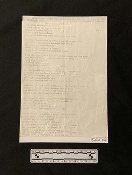 Poem typed in black ink on an A4 page with some small annotations in blue biro ink. There are crease marks where the page has been folded in four and a small tear on the centre right side edge.