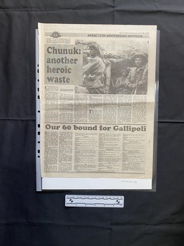 A large newspaper clipping that comprises of two stories with the top story having a black and white photo and seven columns of text and the bottom story having five columns of text