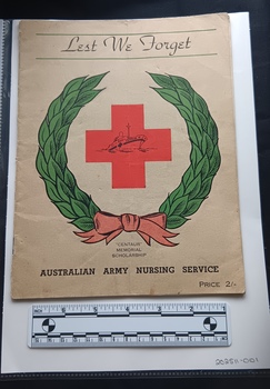 Cream booklet with colour red cross and green wreath