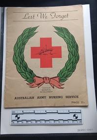 Cream booklet with colour red cross and green wreath