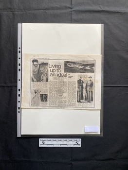 A photocopy of a newspaper clipping that includes a title, captions, three columns of text and four black and white photos