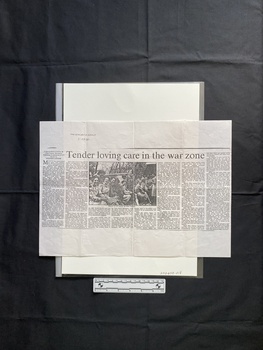 A photocopy of a large newspaper clipping consisting of a title, eight columns of text and a black and white photo