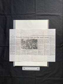 A photocopy of a large newspaper clipping consisting of a title, eight columns of text and a black and white photo
